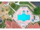 Bird's eye view of a large community pool and spa surrounded by lounge chairs and umbrellas at 4219 Windchime Ln, Lakeland, FL 33811