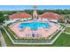 Beautiful community pool and spa surrounded by lounge chairs and a well-manicured lawn at 4219 Windchime Ln, Lakeland, FL 33811