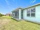 Charming home exterior showcasing a well-maintained lawn and screened-in patio, perfect for relaxing outdoors at 4219 Windchime Ln, Lakeland, FL 33811