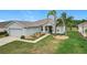 Lovely single-story home with verdant lawn, palm trees, and a welcoming entrance showcasing curb appeal at 4219 Windchime Ln, Lakeland, FL 33811