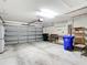 An organized two-car garage features shelving, storage, and work space at 4219 Windchime Ln, Lakeland, FL 33811