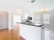 Modern kitchen featuring white cabinets, black countertops, stainless appliances, and breakfast bar at 4219 Windchime Ln, Lakeland, FL 33811