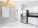 Bright kitchen with stainless steel refrigerator and marble tile flooring at 4219 Windchime Ln, Lakeland, FL 33811