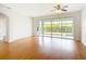 Bright living room featuring hardwood floors, neutral walls, and access to the outdoor lanai at 4219 Windchime Ln, Lakeland, FL 33811