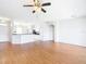 Open-concept living room with hardwood floors flowing into the kitchen, perfect for entertaining at 4219 Windchime Ln, Lakeland, FL 33811