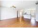 Open-concept living room showcasing hardwood floors, neutral paint, and seamless flow to kitchen at 4219 Windchime Ln, Lakeland, FL 33811