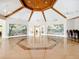 Expansive meeting room with striking wood ceiling, muraled walls, and a polished hardwood floor with geometric design at 4219 Windchime Ln, Lakeland, FL 33811