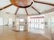 Spacious meeting room with geometric wood floor design, multiple ceiling fans, and walls adorned with nature-themed artwork at 4219 Windchime Ln, Lakeland, FL 33811