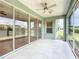 Inviting screened patio with ceiling fan, offering a seamless transition to outdoor living with sliding glass door access at 4219 Windchime Ln, Lakeland, FL 33811