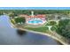 Aerial view of a community pool and clubhouse overlooking the beautiful lake at 4219 Windchime Ln, Lakeland, FL 33811