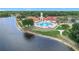 Aerial view of a community pool and clubhouse overlooking the beautiful lake at 4219 Windchime Ln, Lakeland, FL 33811