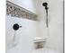 A renovated walk-in shower features pebble accents and a shower seat at 4219 Windchime Ln, Lakeland, FL 33811