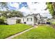 Spacious backyard with lush green lawn, shed, and carport, ideal for outdoor activities at 422 E Belmar St, Lakeland, FL 33803
