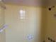 A full bathroom showcasing yellow tiling, and a shower head at 422 E Belmar St, Lakeland, FL 33803