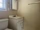 A bathroom featuring a sink with cabinetry and a toilet, with a mirror above the sink at 422 E Belmar St, Lakeland, FL 33803