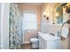 Cozy bathroom with classic fixtures, including a white vanity and patterned shower curtain at 422 E Belmar St, Lakeland, FL 33803