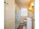Traditional bathroom featuring a white vanity, patterned shower curtain, and tiled floors at 422 E Belmar St, Lakeland, FL 33803