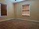 A carpeted room with two windows at 422 E Belmar St, Lakeland, FL 33803