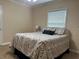 A bedroom with a queen bed, neutral paint, and natural light at 422 E Belmar St, Lakeland, FL 33803