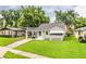 Charming one-story home with carport and well-maintained lawn, surrounded by mature trees at 422 E Belmar St, Lakeland, FL 33803