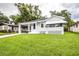 Charming one-story home featuring a well-manicured lawn and inviting covered porch with awning at 422 E Belmar St, Lakeland, FL 33803