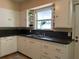 Well-lit kitchen with double sinks, storage, and an exterior door at 422 E Belmar St, Lakeland, FL 33803