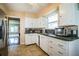Functional kitchen with white cabinets, tile flooring, and essential appliances at 422 E Belmar St, Lakeland, FL 33803