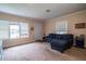 Bright living room with large windows, plush carpet, and a comfortable blue sofa at 422 E Belmar St, Lakeland, FL 33803