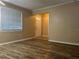 Bright living room with wood-style flooring, large windows, and a view of the front door at 422 E Belmar St, Lakeland, FL 33803