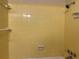 Close-up of a yellow tiled shower area with functional fixtures and a clean, minimalist design at 422 E Belmar St, Lakeland, FL 33803