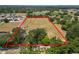 Aerial view showing large land plot outlined in red, surrounded by homes and trees in a quiet neighborhood at 5201 Dorman Rd, Lakeland, FL 33813
