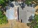 Aerial view showcases a shingle roof, connecting patio, and backyard with mature trees at 5201 Dorman Rd, Lakeland, FL 33813