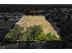 Aerial view of a large parcel of land with trees, surrounded by houses and a bordered in grey at 5201 Dorman Rd, Lakeland, FL 33813