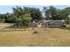An aerial view displays the property's layout with house, guest house, deck, and backyard at 5201 Dorman Rd, Lakeland, FL 33813