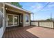Elevated backyard deck overlooking a spacious, grassy field and enclosed by a brown railing for added safety at 5201 Dorman Rd, Lakeland, FL 33813