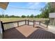 Backyard deck overlooking a large grassy field with a fenced area, perfect for outdoor activities and relaxation at 5201 Dorman Rd, Lakeland, FL 33813
