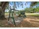Backyard with a wooden swing set at 5201 Dorman Rd, Lakeland, FL 33813