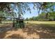 Spacious backyard featuring mature trees, a playground, and a large grassy area perfect for outdoor activities at 5201 Dorman Rd, Lakeland, FL 33813