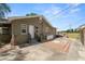 A patio in the backyard leads to a deck with access to the grassy field beyond the property line at 5201 Dorman Rd, Lakeland, FL 33813