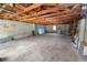 Unfinished basement with exposed wooden beams and cinder block walls at 5201 Dorman Rd, Lakeland, FL 33813
