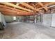 Spacious unfinished basement with concrete floor, wooden rafters, and visible utilities at 5201 Dorman Rd, Lakeland, FL 33813