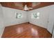 A well-lit bedroom features wood ceiling and floors and two windows at 5201 Dorman Rd, Lakeland, FL 33813