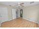 Light bedroom with ceiling fan, wood floors, and two closets at 5201 Dorman Rd, Lakeland, FL 33813