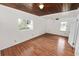 A well-lit bedroom features wood ceiling and floors and two windows at 5201 Dorman Rd, Lakeland, FL 33813