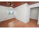 A well-lit bedroom features wood ceiling and floors and one window at 5201 Dorman Rd, Lakeland, FL 33813