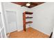 Bedroom featuring built-in wooden shelves, a ceiling fan, wood flooring, and neutral wall paint at 5201 Dorman Rd, Lakeland, FL 33813