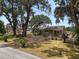 Beautiful home with mature trees, manicured lawn, and a welcoming brick path enhancing its curb appeal at 5201 Dorman Rd, Lakeland, FL 33813