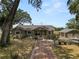 Charming single-story home featuring a brick walkway and well-maintained landscaping, plus a detached two car garage at 5201 Dorman Rd, Lakeland, FL 33813