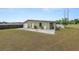 Back exterior view of a one story house with a single car garage and a white picket fence at 5201 Dorman Rd, Lakeland, FL 33813