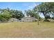 Exterior view showing a deck and large backyard with mature trees and greenery at 5201 Dorman Rd, Lakeland, FL 33813